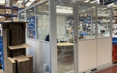 Cabine d'atelier insonorisée NOVOCAB installée au centre d'un atelier de fabricant de robinetterie